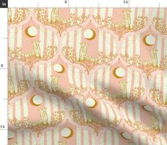 a pink and gold wallpaper with white circles on the top, in front of a ruler