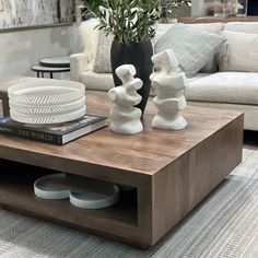 a coffee table with two vases on it