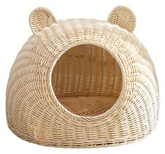 a wicker cat bed with ears on it