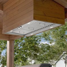 an outdoor grill is shown on the porch with trees in the backgrouds