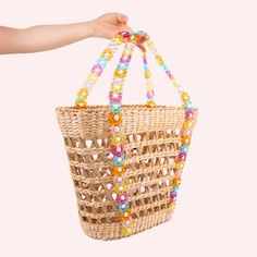 The cutest beaded beach tote is *almost* here. This woven natural straw beach tote is embellished with a unique multicolor beaded top handle. The interior basket is reinforced with sturdy boning so you can carry all of your beach & summertime essentials! PREORDER NOW! These will ship the estimated beginning of August 2024. Dimensions: 18" L x 6" W x 12" H Top handle drop: 7.5" (Top handle carry. This is NOT a shoulder bag.) Bohemian Beaded Beach Bag For Summer, Beaded Beach Bags For Beach Season, Beaded Natural Color Beach Bag, Rectangular Beaded Beach Bag, Beaded Straw Beach Bag, Summer Beaded Bucket Bag, Beaded Natural Straw Bag For Beach, Summer Beaded Rectangular Beach Bag, Beach Beaded Natural Straw Bag