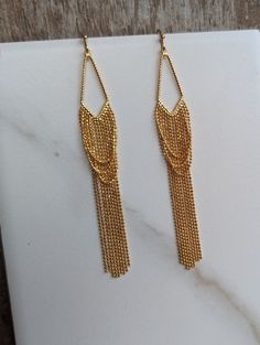 Gold Ball Chain Tassel Earrings - Gold Fringe -  Tassel Charms - 18K Gold Plated Brass - Triangle Shaped Gold Jewelry  These stylish, fun, and stunning earrings are perfect for Vegas, New Year's celebrations, or a night on the town. Gold Plated Ear Wires (if you would like gold-filled ear wires for an additional $6.00, please contact me)   Tassel - 125x13mm Earring Length - 3.5 inches Drop Length - 3  inches Gold Ball Chain, Gold Fringe, Tassel Fringe, Stunning Earrings, Triangle Shape, Nouvel An, Ball Chain, Tassel Earrings, Earrings Gold