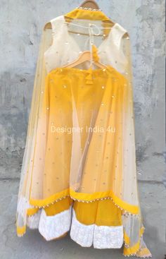 This is Custom Made Yellow Chanderi Silk Wedding Party Wear Lehenha Blouse Dupatta. Fabric and work: Lehenga made using Chanderi Silk fabric with thread work white border attached at border. Blouse is made using threadwork fabric. Dupatta made using Sequines Net. Post your order we will send you a measurements form and you will need to let us know your size details accordingly. I make it exclusively for my customers by using designer high quality fabrics. I will only make it after you confirm yo Yellow Choli With Sheer Dupatta For Navratri, Yellow Floor-length Sharara With Sheer Dupatta, Yellow Art Silk Floor-length Dupatta, Yellow Organza Choli For Wedding, Yellow Dola Silk Choli With Traditional Drape, Yellow Dola Silk Choli In Traditional Drape, Semi-stitched Yellow Sets With Sheer Dupatta, Yellow Chanderi Choli For Wedding, Yellow Organza Choli For Navratri