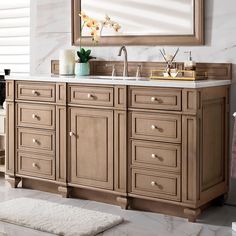 a bathroom vanity with two sinks and a large mirror above it, along with a rug on the floor