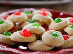 a red bowl filled with cookies covered in candy