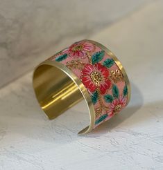 Soft pink flowers and gold embroidery create a dreamy vintage inspired cuff bracelet. This wide cuff bracelet makes quite the statement with it's delicately embroidered floral design. The beaded and thread accents give this cuff bracelet extra elegant details. • Handmade in India • Pink, coral, mint and gold embroidery • Statement making cuff bracelet in vintage design 1 5/8" wide Soft Pink Flowers, Mint And Gold, Wide Cuff Bracelets, Gold Cuffs, Gold Embroidery, Wide Cuff, Pink Coral, Pink Background, Vintage Design