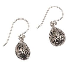 This gorgeous pair of dangle earrings come from the creative mind of artisan Wirabhuwana. Crafted by hand from sterling silver each earring features a three-dimensional drop-shaped design that is decorated with traditional Balinese bun openwork. This elegant pair of earrings make a wonderful accessory for all occasions. Ornate Sterling Silver Teardrop Earrings For Gift, Ornate Sterling Silver Teardrop Earrings As Gift, Sterling Silver Teardrop Earrings With Intricate Design, Traditional Nickel-free Sterling Silver Teardrop Earrings, Sterling Silver Intricate Teardrop Earrings, Artisan Teardrop Earrings For Pierced Ears As Gift, Artisan Sterling Silver Teardrop Dangle Earrings, Artisan Sterling Silver Nickel-free Teardrop Earrings, Artisan Teardrop Earrings As Gift