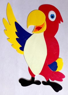 a paper cut out of a colorful parrot