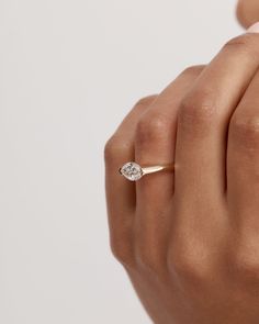 a woman's hand with a diamond ring on it