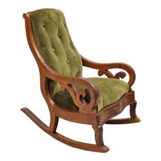 a wooden rocking chair with green velvet upholstered seat and armrests on an isolated white background