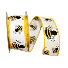 two rolls of yellow and black ribbon with bees on them, one roll is white