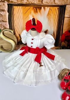 These are pre-order dresses. All of them are handmade smocking. Thank you for supporting a small business. Clothing Care Instructions Most items can be washed safely in cold water on delicate cycle and hung to dry. If the item that you are ordering has red or another bright color in it next to a white or other light color fabric please use a Shout color catcher for the first few washes to avoid bleeding. The reds are pre-washed but they are still red and will likely have some color transfer with White Cotton Holiday Dress, White Embroidered Holiday Dress, White Embroidered Dress For Holidays, White Cotton Smocked Dress With Short Sleeves, Cute Red Smock Dress, White Cotton Christmas Dress, Cute White Smock Dresses, Small Business Clothing, Business Clothing