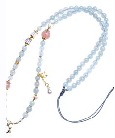 two beaded necklaces with charms and beads on each strand, one is blue