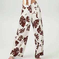 A Pair Of Satin Pants Featuring An Allover Tropical Leaf Print, Mid Rise, Zip Fly With Button Closure, Back Welt Pockets, And A Wide Leg. Content + Care - 100% Polyester - Hand Wash Cold Size + Fit - Model Is 5'8" And Wearing A Small - Measured From A Size Xs - Inseam: 31" Trendy White Wide Leg Pants For Vacation, Forever 21 White Spring Bottoms, Forever 21 High Waist Vacation Bottoms, Forever 21 High-waisted Summer Pants, Forever 21 High-waist Bottoms For Vacation, Forever 21 High Waist Bottoms For Vacation, High Waist Bottoms By Forever 21 For Beach, High Waist Forever 21 Bottoms For Vacation, Trendy Summer Pants By Forever 21