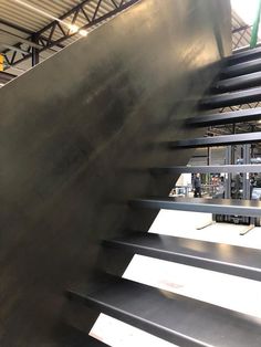 an escalator in a building with metal railings