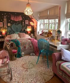 a bedroom decorated in pink, blue and white with lots of decor on the walls