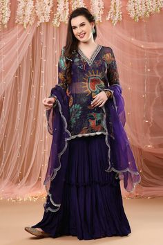 Purple floral print sheer kurta with zardozi embroidered detail. Paired with solid gharara and dupatta.
Component: 3
Pattern: Embroidered, Printed
Type Of Work: Zardozi work, Floral print
Neckline: V neck
Sleeve Type: Full sleeves
Fabric: Crepe silk, Chiffon, Organza
Color: Purple 
Other Details: 
Scallop hem kurta
Churidar sleeves
Note: Crop top worn by the model is not for sale
Occasion: Reception - Aza Fashions Semi-stitched Sharara For Designer Wear Diwali, Semi-stitched Designer Sharara For Navratri, Designer Semi-stitched Sharara For Navratri, Bollywood Georgette Sharara For Transitional Season, Transitional Season Bollywood Style Georgette Sharara, Purple Sharara For Transitional Season, Traditional Purple Palazzo Set With Sheer Dupatta, Purple Palazzo Set With Sheer Dupatta For Diwali, Bollywood Style Designer Purple Sharara