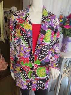 "70s'/80s' \"FUNKY !\", ladies (unisex) bright colorful floral/abstract print jacket by Adolfo International in a size medium.  Jacket has small shoulder pads, one large white button front closure, large front slot pockets, fully black lining, and outer fabric is linen/cotton and dry clean only for care.  Fabric print is colorful flowers etc. in red, yellow, black, purple, white, mint, brown, and in Great condition.  Shoulders 20\", Bust/Chest 44\", Waist 42 1/2\", Sleeves 22 1/2\", Length 30\", Fall Printed Multicolor Blazer, Fall Multicolor Printed Blazer, Retro Multicolor Summer Outerwear, Multicolor Printed Blazer For Spring, Retro Spring Outerwear With Graphic Print, Retro Graphic Print Outerwear For Spring, Retro Multicolor Blazer For Fall, Retro Multicolor Fall Blazer, Multicolor Graphic Print Outerwear For Summer