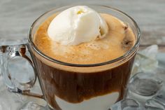 a glass mug filled with liquid and ice cream