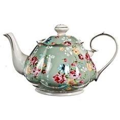 a tea pot with flowers painted on it