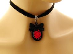 "Gothic choker Goth necklace Gothic jewelry Goth jewelry Gift for her Red Rose Black Cameo Necklace on Black Velvet choker Matching ring Gothic red rose cameo on a black background, set in a black acrylic bow tie topped frame. The cameo hangs from a velvet choker with a silver toned extender chain adjustable from 12.5 to 14.25 inches Cameo pendant - 2 inches Velvet choker necklace: 12.5-14.24 inches Arrives with a Marty White card in a lovely decorative bag and bubble wrap packaging. Facebook: h Black Vintage Jewelry For Valentine's Day, Vintage Black Jewelry For Valentine's Day, Gothic Adjustable Choker For Valentine's Day, Adjustable Gothic Choker For Valentine's Day, Gothic Red Jewelry Gift, Red Gothic Jewelry For Gift, Red Gothic Jewelry Gift, Adjustable Red Gothic Jewelry, Black Vampire Style Choker As Gift