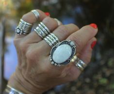 "WHITE BUFFALO RING set in oxidized Sterling Silver.  WHITE BUFFALO STATEMENT RING handcrafted in oxidized Sterling Silver featuring a predominately white colored cabochon.  Signed and dated original statement ring; designed and created for the jewelry collectors and lovers of bohemian chic rings and original wearable art jewelry.   SIZE 8  BAND STYLE: OPEN STYLE - WAVY - four (4) ridge handmade sterling silver band (4RO-W). Band is approximately .3\" wide.   This width is important when conside White Stone Ring, Single Stone Ring, Chic Rings, Wearable Art Jewelry, Handmade Silver Ring, Silver Design, Gemstone Jewelry Handmade, Single Stone, Ring Boho