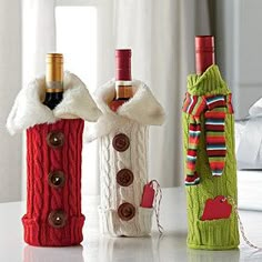 two wine bottles made out of sweaters are sitting next to each other