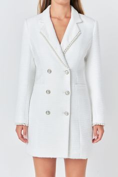 Upgrade your wardrobe with our elegant Pearl Trim Blazer Dress. This sophisticated blazer-style dress is crafted from high-quality tweed fabric, giving it a luxe look and feel. The mini length makes it perfect for any occasion, while the collar and lapel add a touch of chicness. The subtle pearl trim detailing adds a touch of glamour to this classic dress. From formal events to day-time outings, this versatile dress is a must-have. Shop now and elevate your style game with our Pearl Trim Blazer Dress. Tweed Blazer dress Mini length Collar and lapel long sleeves Double breast Pearl button Pearl trim detail at lapel and sleeve Lining Hand wash cold Do not bleach Do not tumble dry Iron low Shell: 100% Polyester Lining: 100% Polyester HN2015D Total length: 33.5" Bust: 34.5" S WHITE: Height 5'9 Elegant Spring Tweed Dress, Fitted White Tweed Blazer, Elegant Fitted Tweed Blazer, Elegant Single-breasted Mini Blazer, Luxury Tweed Dress For Winter Formal, Luxury Tweed Dress For Formal Winter Occasions, Luxury Tweed Dress For Formal Winter Events, Elegant Fitted Tweed Dress For Wedding, Luxury Winter Tweed Dress For Formal Occasions