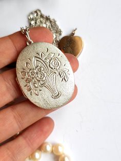 A wonderful very big silver Locket with scrolling foliage details. Very beautiful  Metall -    silver 835 Measurements  pendant  -   Length  5.  cm 1.96.  inches  necklace  60 cm   or 23.62 inches Weight  with chain          - 17.60   gramm Excellent vintage condition. Don't forget visit my collection  https://myoldvintage.etsy.com PLEASE VIEW ALL PHOTOS AND VIDEO AS THEY ARE A PART OF THE DESCRIPTION Please note that you should expect some wear with all antique and vintage pieces, it is part of their history and their charm. If you have any further questions or you need some help with something, please get in touch with us. We will be happy to help you. The other jewels on the last page you can find in my other auction. please visit Instagram my name is - MyOldVintage - Please feel free t Large Locket, Gift For Love, Silver Locket, Love Photo, Photo Pendant, Silver Lockets, Vintage Pieces, Locket Necklace, Necklace Gift