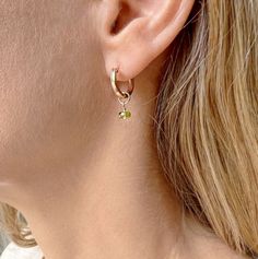 Our peridot birthstone hoop earrings carry a dainty peridot gemstone drop and are the perfect everyday earrings. The hoops and peridot birthstones are both lightweight and minimalist and are available in rose gold filled, gold filled and sterling silver. We love how customizable they are with many birthstone and other popular gemstone options. You also have the option of sliding the gemstones off and wearing as simple hoops.  Model is shown wearing our peridot birthstone hoop earrings in rose go Earrings For Mom, Peridot Birthstone, Rose Gold Hoop Earrings, Peridot Earrings, August Birthstone Jewelry, Birthstone Earrings, August Birthstone, Earrings Dainty, Peridot Gemstone