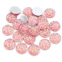 pink and white glittered buttons on a white background