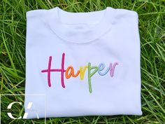 Rainbow Custom 3D Embroidered Kids Tshirt Personalised Kids Name Introducing our adorable 3D embroidered kids t-shirt featuring a vibrant rainbow design that is completely custom and sure to brighten up any child's day!    Perfect for adding a pop of color to any outfit, this t-shirt is both stylish and practical for your child to wear and play in.     Treat your little one to this unique and fun piece that is guaranteed to become a favorite in their wardrobe!  Care instructions* To keep your ga Multicolor Crew Neck Top With Embroidered Logo, Cute White T-shirt With Letter Embroidery, White Cute T-shirt With Custom Embroidery, Cute White T-shirt With Embroidered Logo, Cute White T-shirt With Machine Embroidery, Cute White T-shirt With Custom Embroidery, Fun Multicolor Shirt With Name Print, Multicolor Embroidered Crew Neck T-shirt, Cute Multicolor T-shirt With Name Print