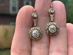 "Set in 18k white gold, these deco diamond dangle earrings are ethereal. They date from the 1920s. The ornate and exquisite filigree work of the magnificent mounting makes room for the star of the show. They center of each earring holds a 1.00 ct old European cut diamond for a total approx. weight of 2.00 ct. Giving way way to the stream of fluid diamond dazzle are 2 smaller diamonds set at the top to complete this magical earring. The diamonds are I in color and SI2 in clarity. This is decadent Elegant Platinum Diamond Earrings Hallmarked, Platinum Hallmarked Earrings For Anniversary, Platinum Hallmarked Anniversary Earrings, Evening Platinum Diamond Cut Earrings, Art Deco White Gold Diamond Earrings With Brilliant Cut, Vintage Platinum Earrings With Brilliant Cut, Hallmarked Diamond Earrings For Evening, Hallmarked Platinum Diamond Earrings For Wedding, Wedding Platinum Diamond Earrings Hallmarked