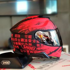 the helmet is red and black with chinese writing on it, along with other items