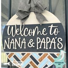 a welcome sign hanging on the front door of a building that says, welcome to nanna & papa's