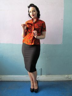 "Super cute novelty print silky blouse from the 1940s. Button up style with an ascot tie collar. Elastic inserts at the waist sides add a bit of flex room in the waistline. Measurements: // Shoulders: up to \" taken flat Bust: 40\"max Waist: 30\" to 32\" max Length: 22\"" Retro Office Blouse With Button Closure, Retro Collared Blouse For Work, Fitted Retro Workwear Blouse, Retro Blouse With Peter Pan Collar, Retro Workwear Blouse With Peter Pan Collar, Retro Blouse With Peter Pan Collar For Vintage Fashion, Retro Fitted Blouse For Office, Retro Peter Pan Collar Blouse For Work, Vintage Tie Neck Office Top