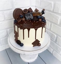 a chocolate cake with white frosting and toppings