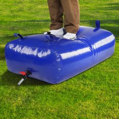 a man standing on an inflatable water tank