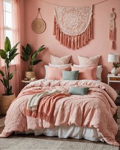 a bed with pink sheets and pillows in a bedroom next to a potted plant