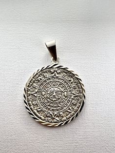 Sterling Silver Aztec Calendar Mayan Sun Charm Pendant Necklace Diamond-Cuts pre-Columbian-style medallion necklace pendant or bracelet charm depicting the Aztec/Mayan sun god exquisitely crafted in genuine 950 sterling silver with dazzling cut details Artisan Silver Jewelry Stamped 925, Silver Pendant With Diamond Cut, Silver Pendant Jewelry With Diamond Cut, Silver Diamond Cut Pendant Jewelry, Traditional Medallion Jewelry With Polished Finish, Traditional Polished Medallion Jewelry, Artisan Silver Jewelry Hallmarked, Etched Sterling Silver Round Necklace, White Gold Intricate Medallion Jewelry