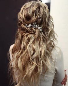 the back of a woman's head with long wavy hair