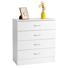 a white chest of drawers with flowers and a picture frame on it's top