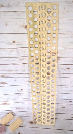 a large yellow metal grate sitting on top of a white wooden floor next to a pair of scissors