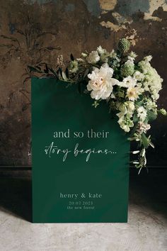 a green sign with white flowers on it and the words and so their story begins