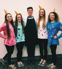 three girls and one boy are dressed up as ice cream cone hats while standing in front of a wall