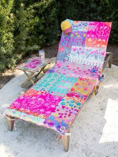 a lawn chair with a colorful blanket on it