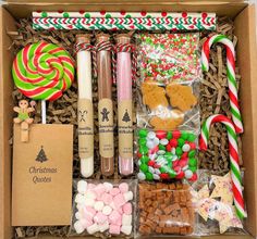 a box filled with lots of different types of candies and candy canes in it