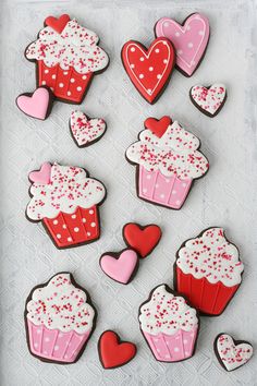 decorated cookies in the shape of hearts and cupcakes