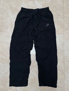 These pants are super hip and comfortable. They've got that full wide leg more baggy look, which is back. They are old school Nike. They must be bought to be worn.  Brand: Nike Size: Large Material: Polyester nylon cotton Measurements in inches Waist 32-36 Inseam 32 1/1.9 #21 I do accept returns within 30 days of purchase of all vintage items. The item must be in the same condition in which it shipped and preferably with the tags still on. The customer is responsible for all shipping costs and there is a 20% restocking fee for all returns. Vintage Nike Clothing, 90s Wide Leg Parachute Pants For Streetwear, Baggy Parachute Pants For Streetwear And Sportswear, Baggy Parachute Pants For Streetwear, 90s Style Black Wide Leg Pants, Sporty Wide-leg Parachute Pants For Streetwear, 90s Parachute Pants For Streetwear, Sportswear Style Parachute Pants For Streetwear, Streetwear Full Length Parachute Pants