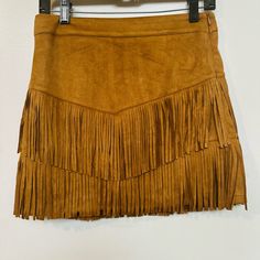 Add A Touch Of Western Style To Your Wardrobe With This Fort Worth Camal Fringe Skirt. The Skirt Features A Solid Pattern And Is Made Of A Combination Of Polyester And Spandex, With A Suede Fabric Type. It Has A Mid-Rise And A Zip Closure For Ease Of Wear. The Skirt Is Perfect For Travel, Parties, Or Casual Occasions, And Comes In A Size Xs. It Also Includes Built-In Shorts For Added Comfort. The Brown Color And Fringe Accents Give The Skirt A Unique Look That Is Sure To Make A Statement. Whethe Casual Fringe Skirt For Fall, Casual Fringe Mini Skirt, Casual Mini Skirt With Fringe, Trendy Fringe Skirt, Fitted Casual Skirt With Fringe, Casual Fitted Skirt With Fringe, Casual Fitted Fringe Skirt, Fringe Skirt, Suede Fabric